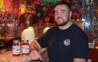 Image of Zander Fagerson and 2 bottles of Highland Moon Moonshine.